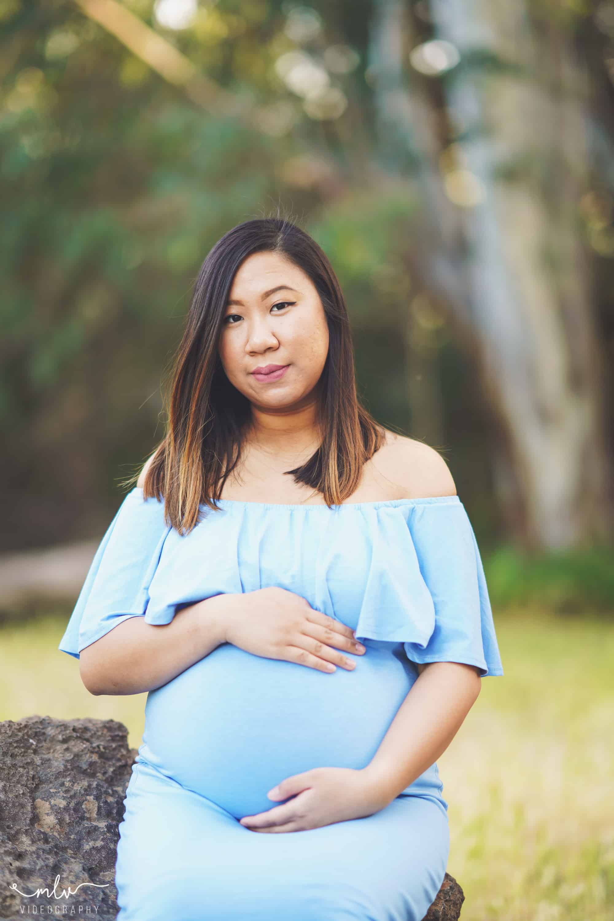 Mother-to-be posing for her maternity photo shoot session, wearing a baby blue dress at Vasona Park in Los Gatos, CA.